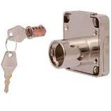 Picture chrome metal desk lock with locking barrel removed barrel sited nearby with two keys on a ring inserted
