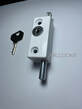 Picture whitco white coloured window lock chrome locking bolt inserted in locked position chrome locking cylinder in face of lock drill hole in top and bottom of face of lock cylinder key nearby